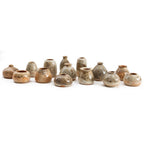 Collection of Stardust bud vases showing glaze variation from grey to cream to apricot