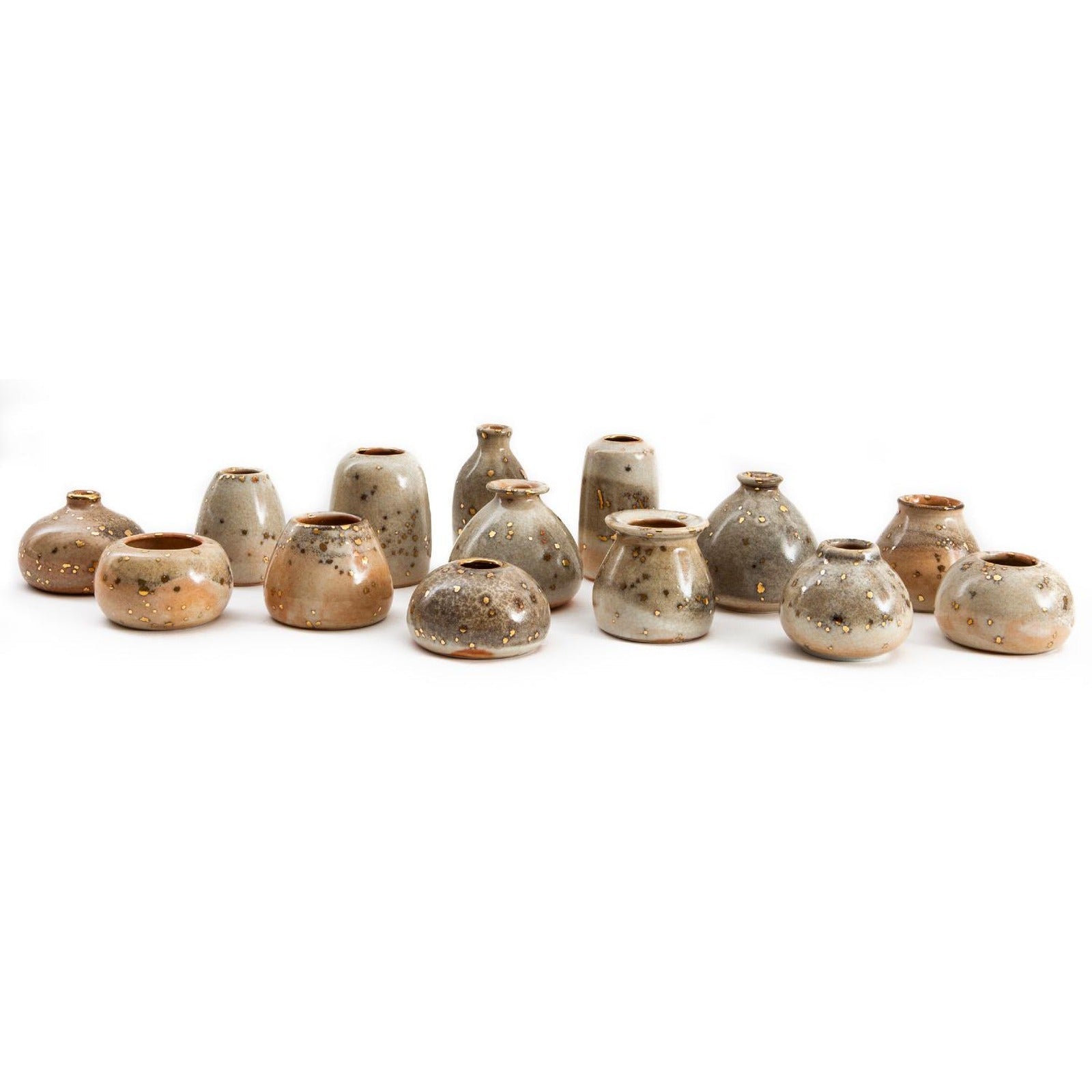 Collection of Stardust bud vases showing glaze variation from grey to cream to apricot